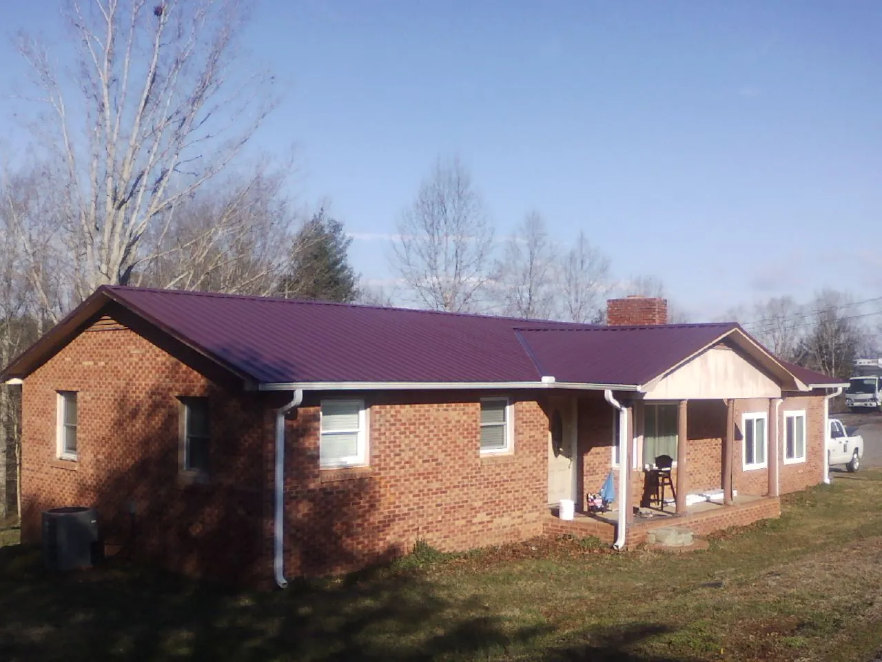 Burgundy metal roof on a brick ranch home with a new addition in Redfield